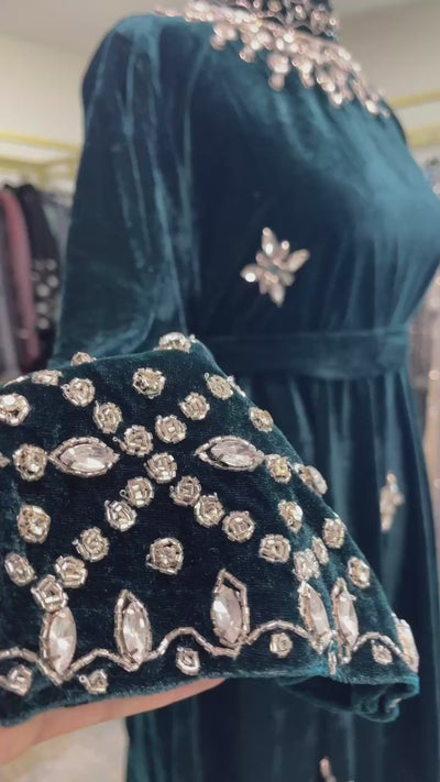 Dark green velvet abaya gown with silver rhinestone beadwork on sleeves and neckline